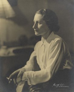 Portrait of Vera Brittain wearing a white blouse and holding a cigarette